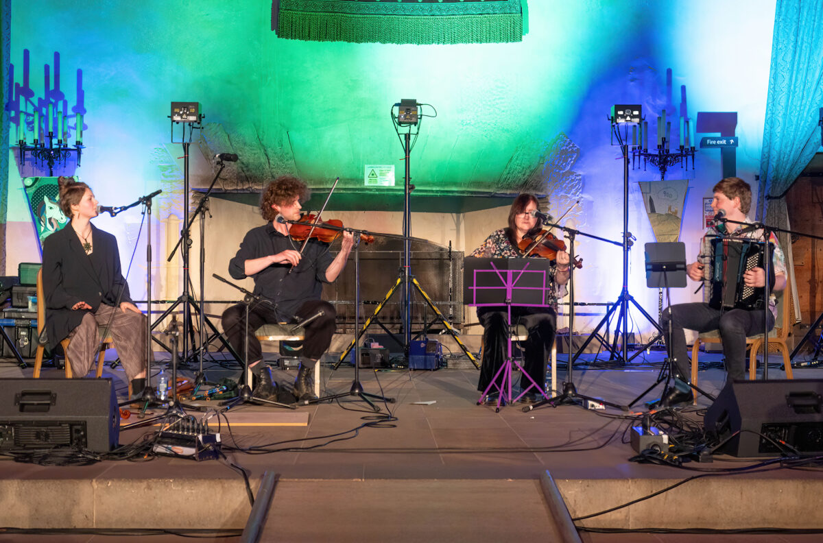 Musicians playing instruments inside a hall